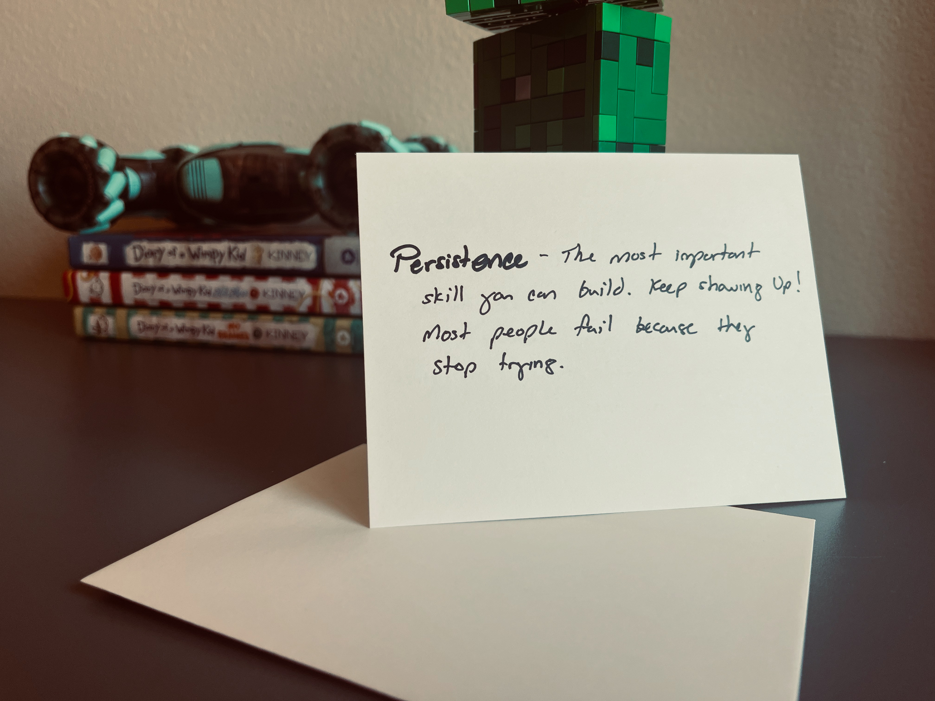 Front of one of the original handwritten cards Dad wrote for his sons, reading 'Persistence — the most important skill you can build. Keep showing up! Most people fail because they stop trying.'